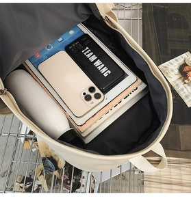 Detailed view of the spacious inner compartment of the beige minimalist laptop backpack