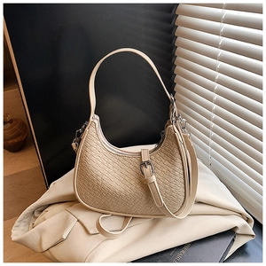 Detailed macro view of beige woven texture and silver zipper on crescent hobo bag