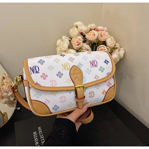 Detail of vintage monogram crossbody bag featuring colorful logo pattern and gold hardware