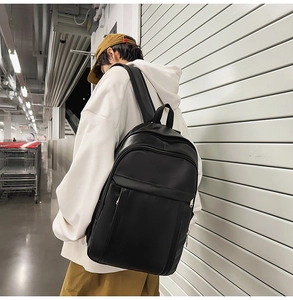 Minimalist black leather backpack for college students with a hidden zipper detail