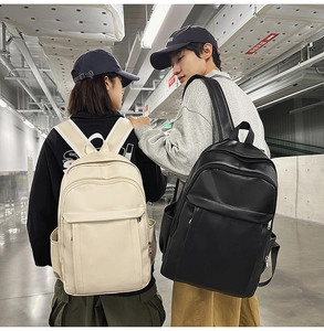 Detailed view of large-capacity backpacks in beige and black for travel and commuting