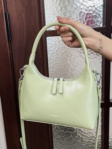 Light green crescent moon hobo bag in glossy leather with detachable shoulder strap