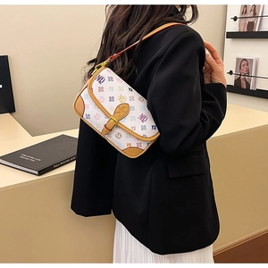 Close-up of stylish crossbody bag with colorful logo prints and brown leather trim