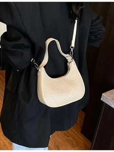 Beige woven hobo bag for women with short handle and detachable strap on model