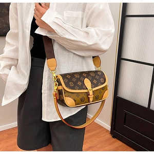 Detail of vintage crossbody bag with MQ monogram and adjustable wide woven strap