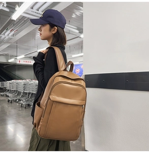 Brown PU leather backpack with minimalist design and large capacity shown on model