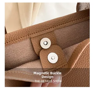 Detailed macro view of the silver magnetic closure on a brown lychee pattern leather bag