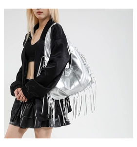 Detail of silver metallic fringe tote bag showing the reflective texture and long tassels