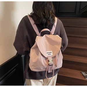Rear view of a light purple waterproof nylon backpack on stairs for daily travel
