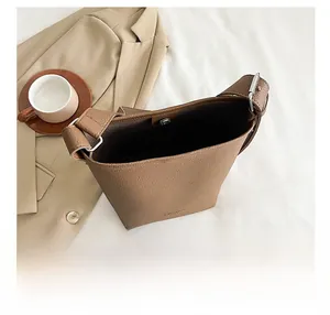 Detailed top view of brown pebble leather bucket bag showing spacious interior and magnetic snap