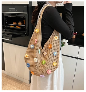 Detail of hand-woven shoulder bag featuring colorful 3D knitted flower decorations
