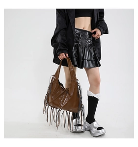 Close-up of brown PU leather hobo bag featuring dense retro tassels and large capacity