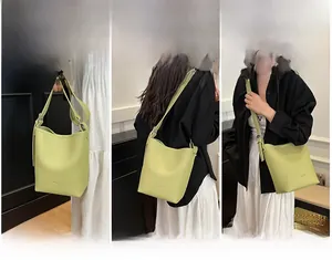 Three-way carry view of a lime green lychee grain leather bucket bag with wide strap