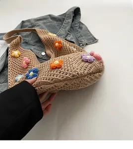 Detail of handmade crochet tote bag featuring multi-color 3D floral embroidery and hollow knit