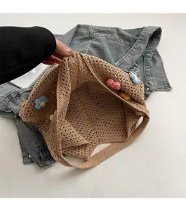 Detail of spacious interior of a handmade crochet bag with floral patterns
