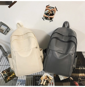 Close-up of the multi-pocket design on synthetic leather travel backpacks in two colors