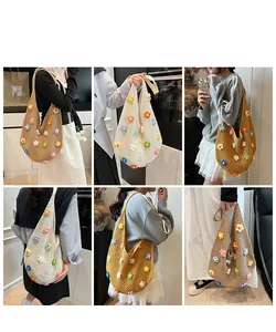 Detail view of handmade crochet tote bag with colorful 3D floral embroidery and mesh texture