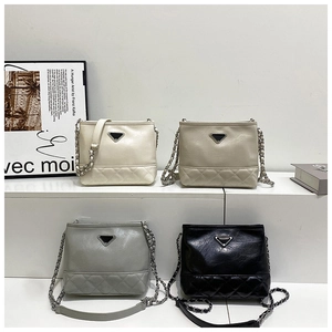 Detail of four bucket bags in cream, apricot, grey and black with diamond quilting