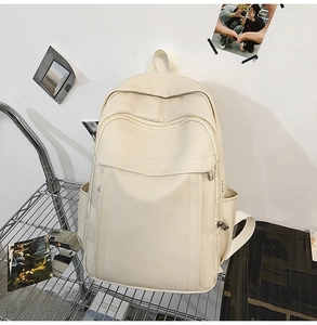 Detail view of large capacity cream backpack on industrial metal shelf showing textured fabric