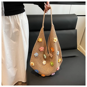Close-up of hand-woven tote bag featuring colorful crochet floral patterns and textures