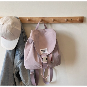Detail of pink Morandi nylon backpack featuring adjustable straps and metal buckle closure
