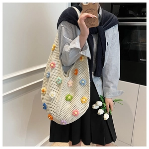 Detail of hand-woven cream crochet shoulder bag with colorful 3D floral embroidery