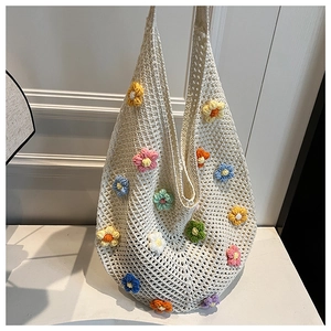 Close-up of handmade white crochet tote bag featuring vibrant 3D floral embroidery detail
