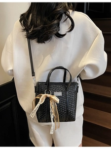 Fashionable black woven texture bucket bag with lace bow and silver metal charm