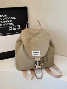 Khaki canvas backpack with large capacity flap design and fashion woven label
