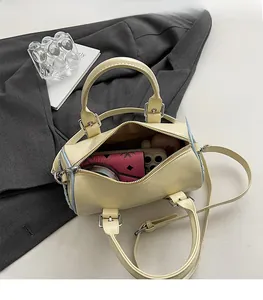 Top view of cream Boston bag showing spacious interior with phone and wallet