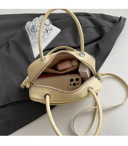 Internal view of pale yellow pillow bag showing large capacity and smooth texture