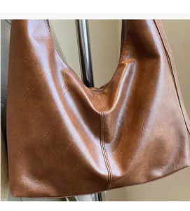 Detailed macro view of soft textured vintage PU leather and zipper on brown tote bag