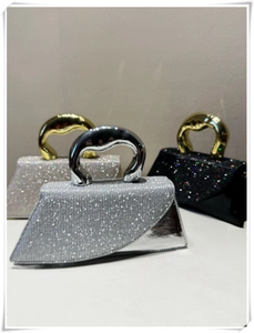 Detailed view of luxury evening bags with shimmering rhinestones and metallic handles