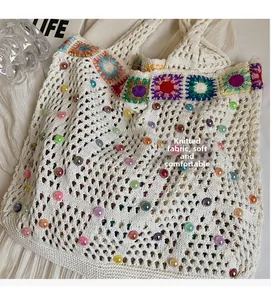 Detailed knit texture of off-white tote bag with colorful crochet flowers and beads