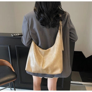Minimalist large capacity beige hobo bag with vertical stitching and adjustable shoulder strap