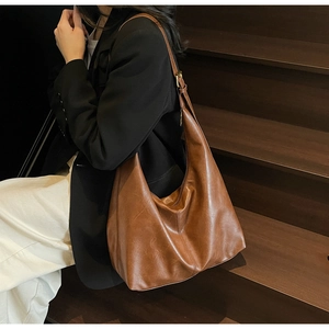 Detail of the vintage brown PU leather texture on a large capacity Hobo tote bag