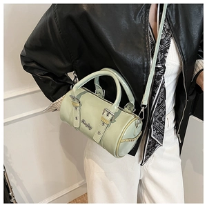 Detail of light green patent leather mini boston bag with silver hardware and woven trim