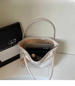 Interior view showing the large capacity and zipper closure of the cream tote bag