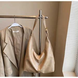 Detail view of khaki PU leather hobo bag with adjustable strap and textured finish