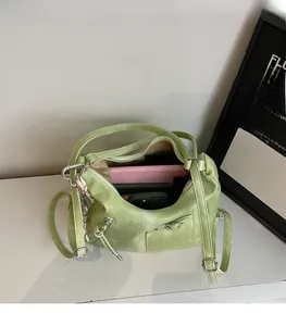 Detail view of spacious inner compartment of the light green tote bag with heart buckle