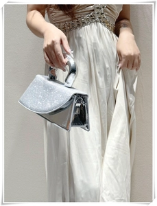Chic silver crossbody bag with sparkling rhinestones and a unique U-shaped metal handle