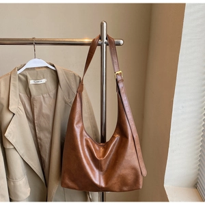 Detail view of vintage brown PU leather tote bag with adjustable metal buckle strap