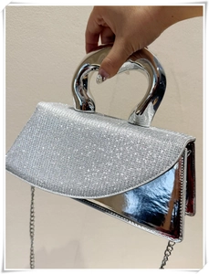 Silver square handbag with heart-shaped metal handle and sparkling rhinestone flap cover