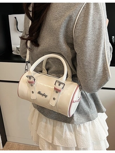 Minimalist white cylindrical boston bag with pink trim and silver logo for women