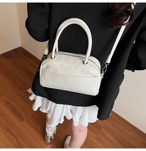 Top view of cream white lychee texture bowler bag styled with casual outfit