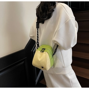 Detail of avocado-themed crossbody bag featuring green contrast and adjustable strap