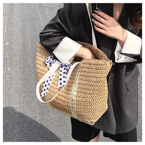 Detail of straw tote bag with polka dot scarf and durable woven shoulder straps