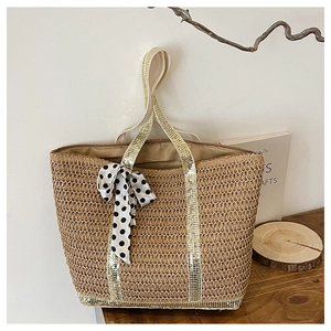 Detail of woven straw tote bag with gold sequins, polka dot scarf, and fabric lining