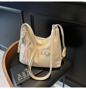 Detailed view of cream PU leather tote bag texture and front pocket with silver buckle