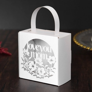 White laser-cut gift box with 'Love You Mom' floral pattern and carrying handle
